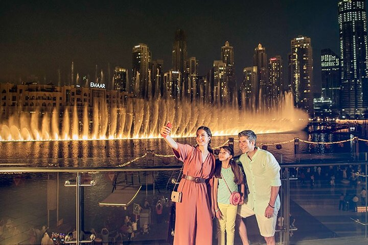 Experience the magic of the Dubai Fountain's mesmerizing water show against the backdrop of towering skyscrapers creating unforgettable memories amid the shimmering lights of this iconic city.
